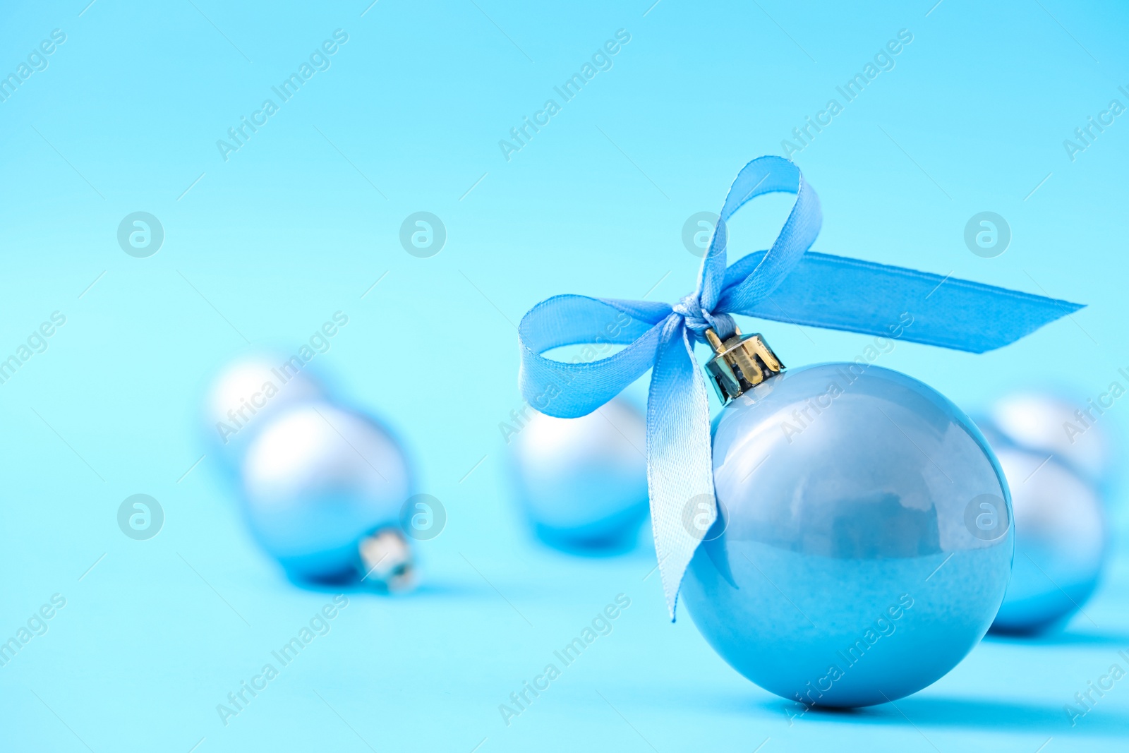 Photo of Beautiful Christmas balls on light blue background. Space for text
