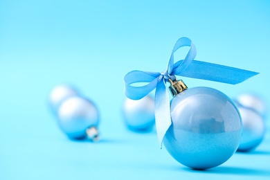 Photo of Beautiful Christmas balls on light blue background. Space for text