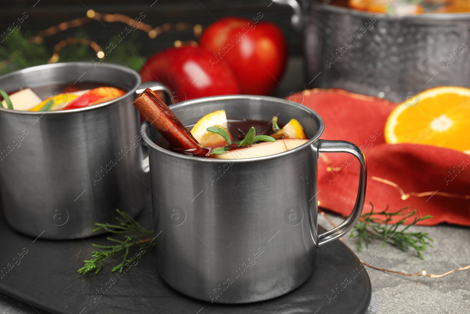 Photo of Tasty mulled wine with spices on grey table