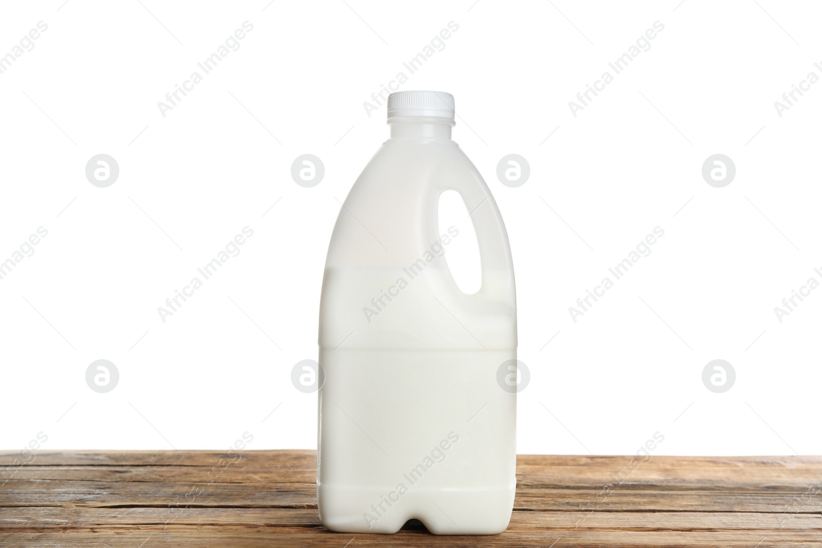Photo of Gallon bottle of milk on wooden table
