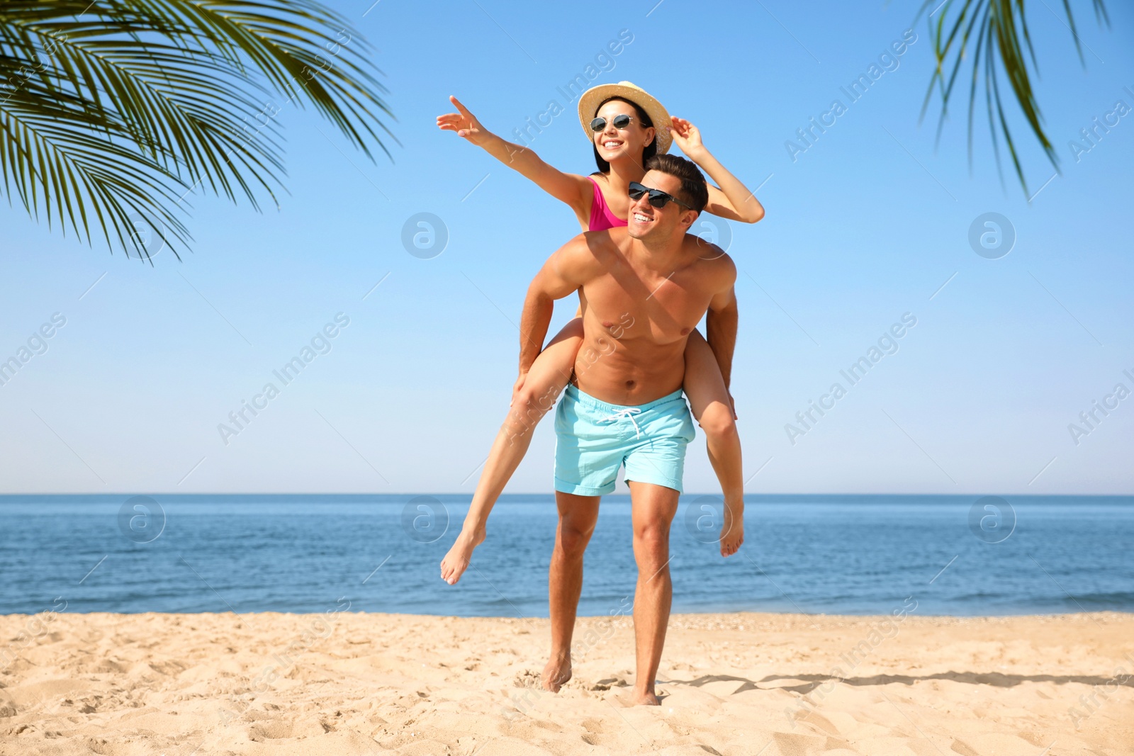 Photo of Happy couple having fun on sunny beach