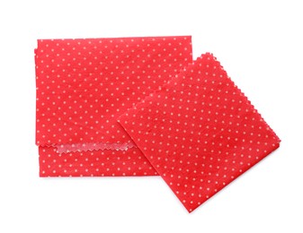 Photo of Red reusable beeswax food wraps on white background, top view