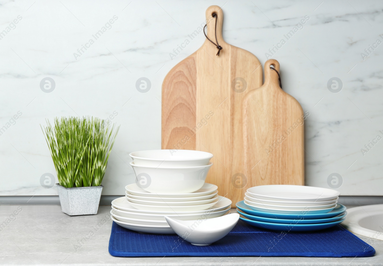 Photo of Different clean plates on counter in kitchen