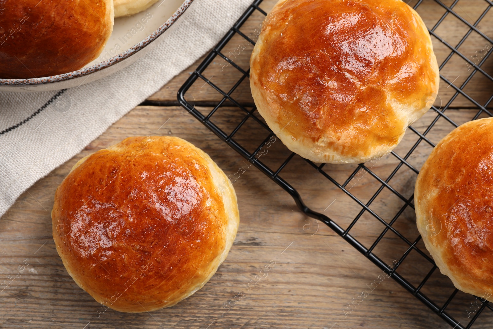 Photo of Tasty scones prepared on soda water on wooden table, flat lay