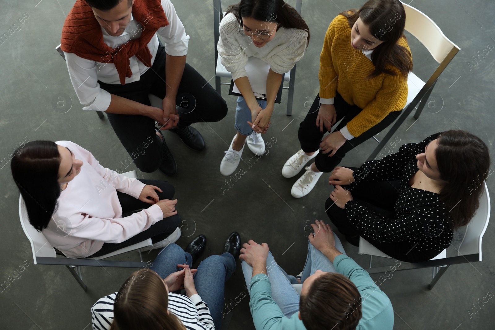 Photo of Psychotherapist working with patients in group therapy session, top view