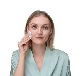 Photo of Young woman cleaning her face with cotton pad on white background
