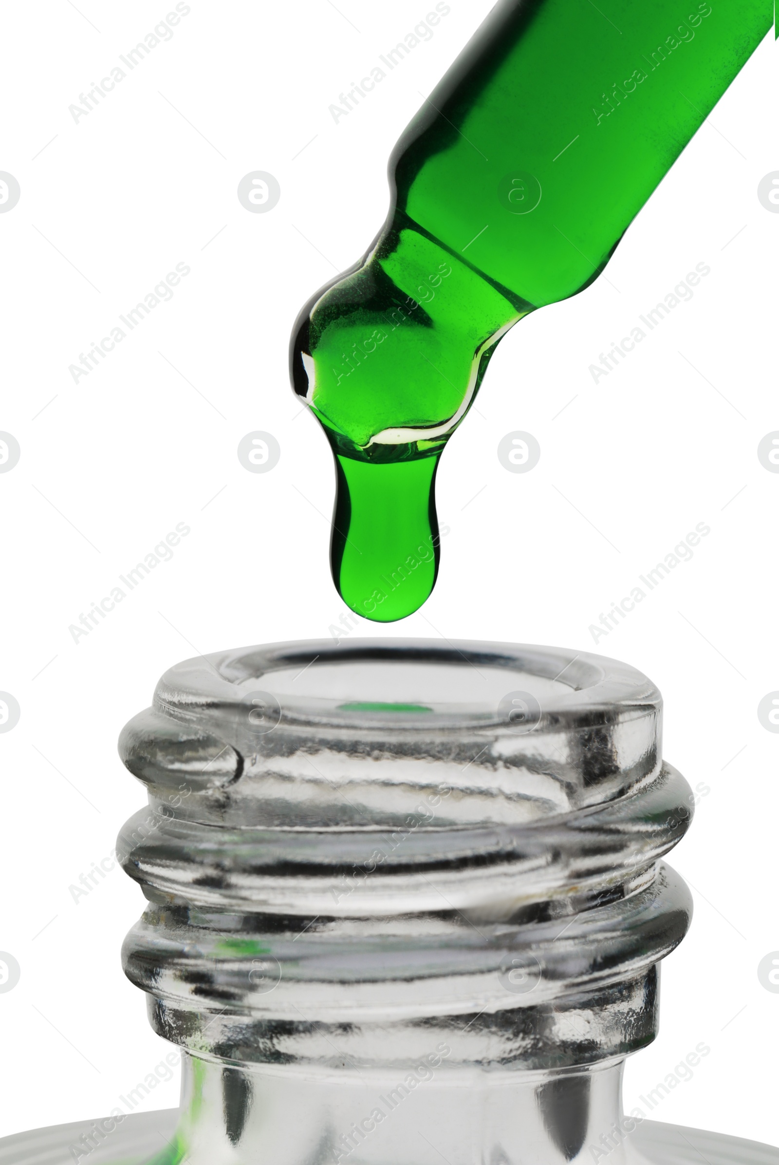 Photo of Dripping green facial serum from pipette into glass bottle on white background, closeup