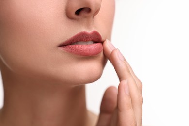 Woman with beautiful lips on white background, closeup