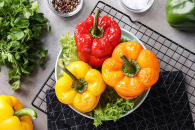 Photo of Tasty stuffed bell peppers and ingredients on table, flat lay