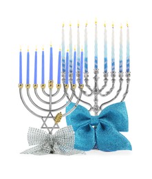 Photo of Hanukkah celebration. Menorahs with bows isolated on white