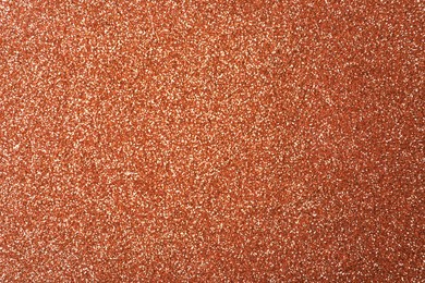 Photo of Beautiful shiny copper glitter as background, closeup