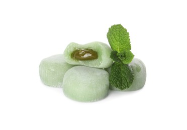 Photo of Delicious matcha mochi and mint leaves on white background