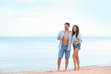 Happy young couple spending time together on beach