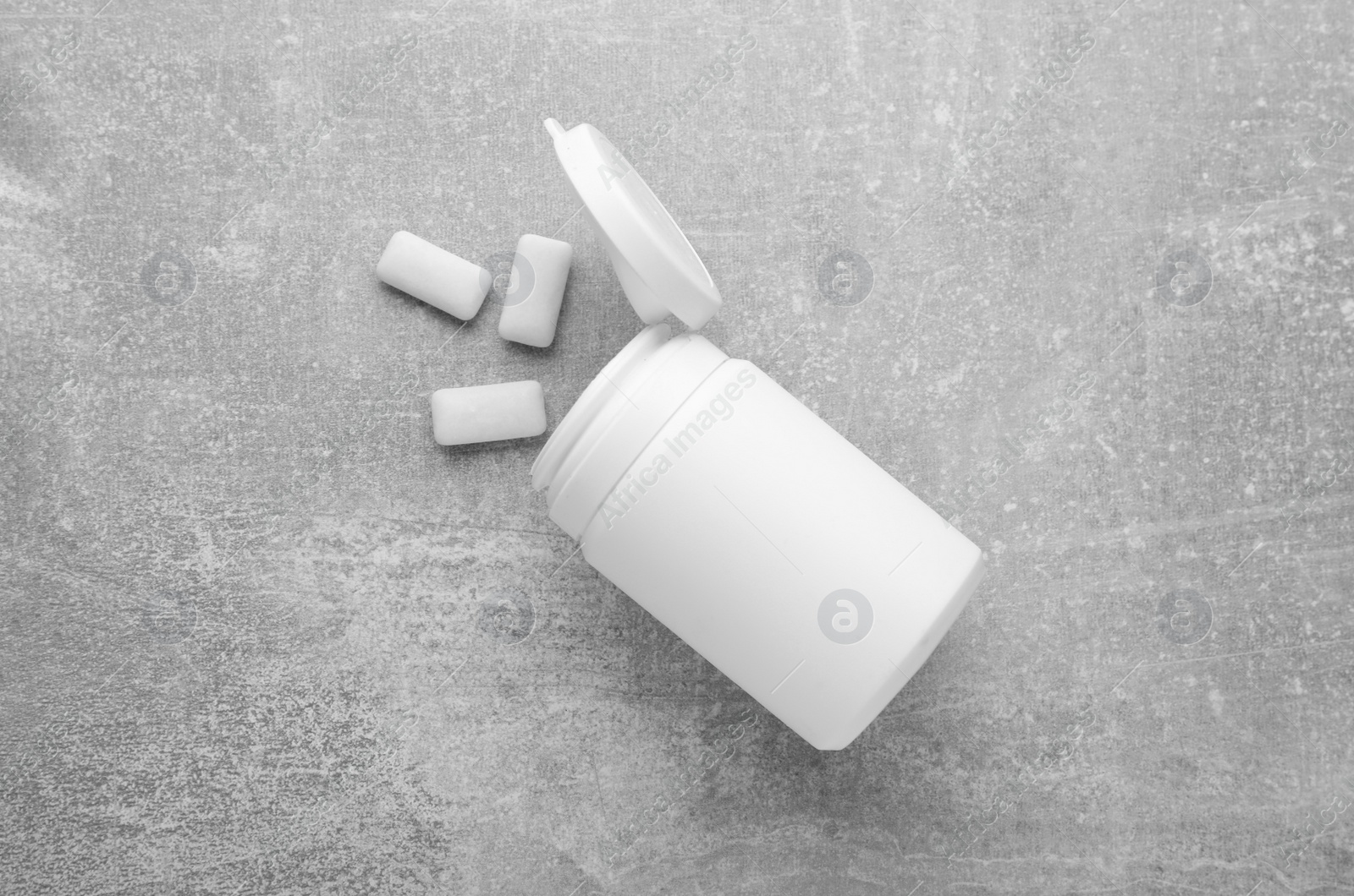 Photo of Jar with chewing gums on light grey table, flat lay