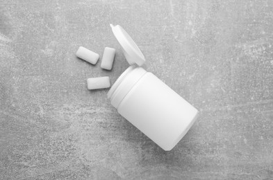 Photo of Jar with chewing gums on light grey table, flat lay