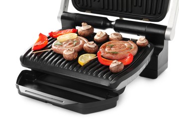 Photo of Electric grill with homemade sausages, mushrooms and bell pepper isolated on white