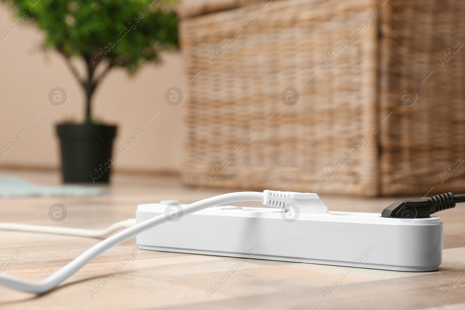 Photo of Extension cord on floor indoors, space for text. Electrician's equipment