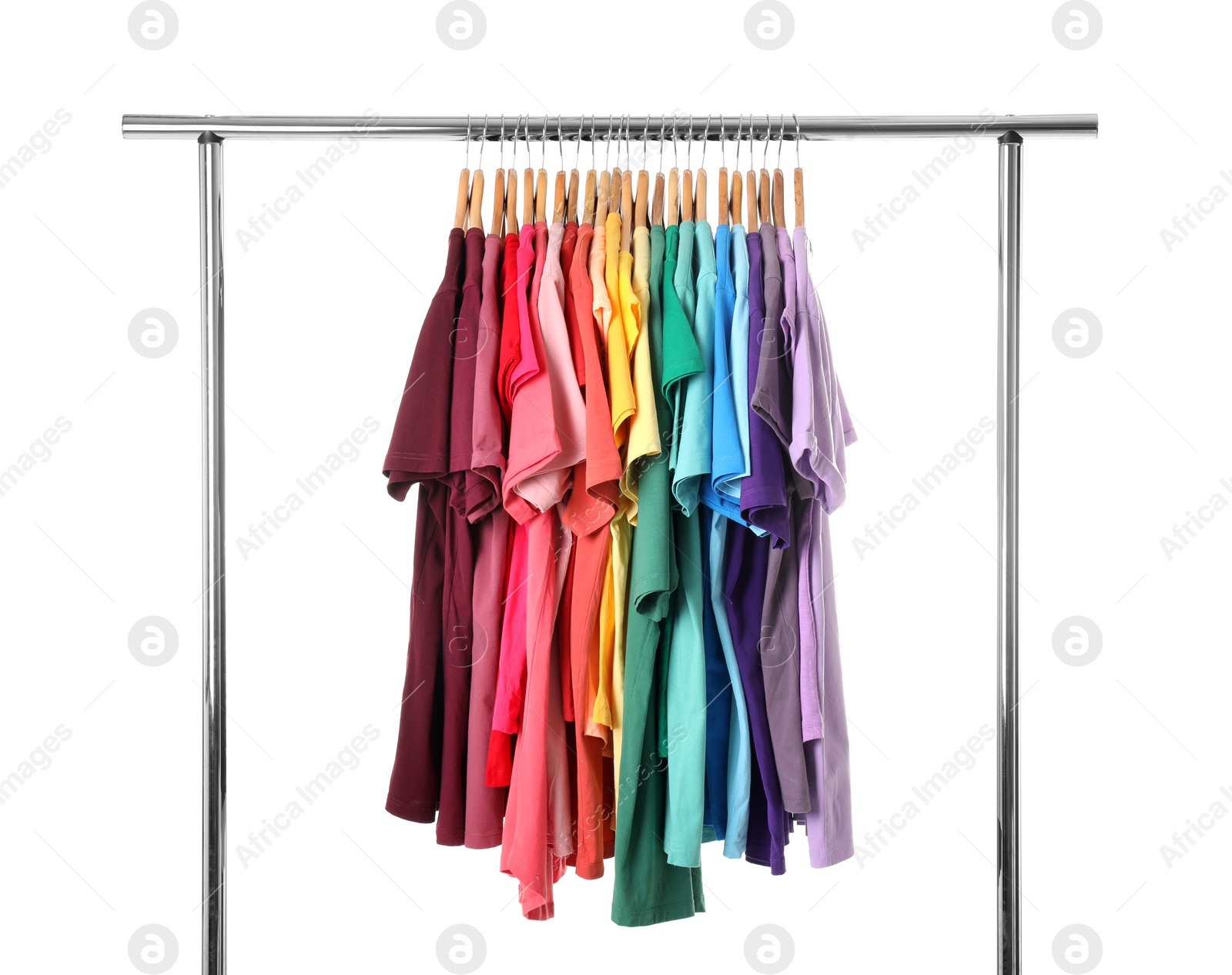 Photo of Rack with rainbow clothes on light background