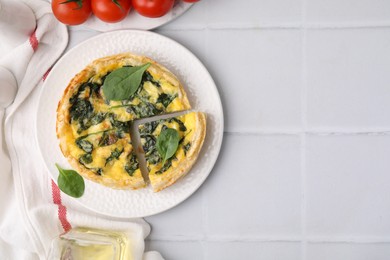 Photo of Delicious pie with spinach on white tiled table, flat lay. Space for text