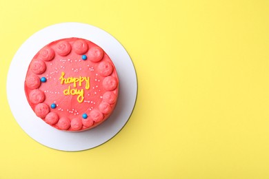 Photo of Cute bento cake with tasty cream on yellow background, top view. Space for text