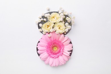 Photo of Number 8 shape hole in white paper with beautiful flowers, top view