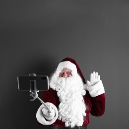 Photo of Authentic Santa Claus taking selfie on grey background