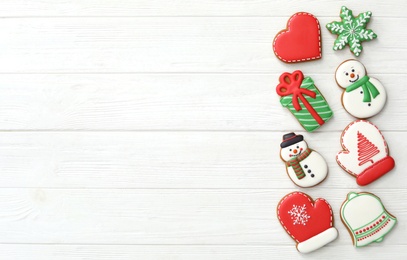 Many different delicious Christmas cookies on white wooden table, flat lay. Space for text