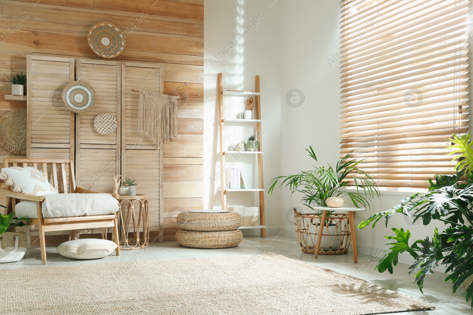 Photo of Stylish living room interior with comfortable wooden armchair and beautiful houseplants