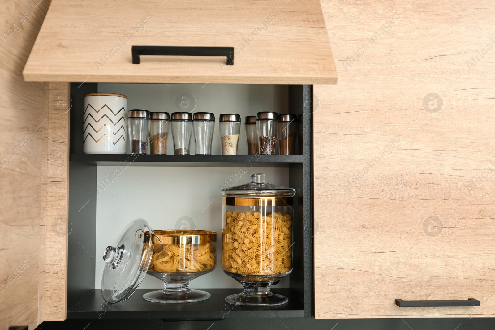 Photo of Products in modern kitchen glass containers on shelf