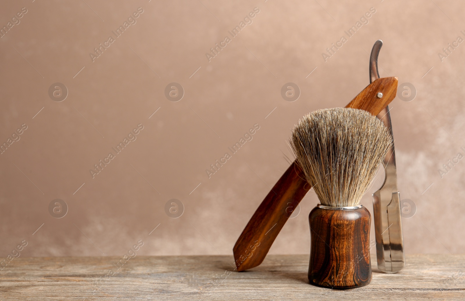 Photo of Shaving accessories on table against color background with space for text