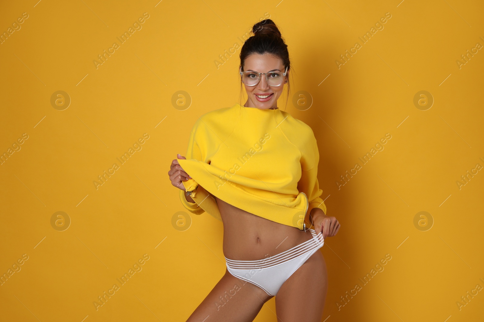 Photo of Beautiful woman in white panties on yellow background