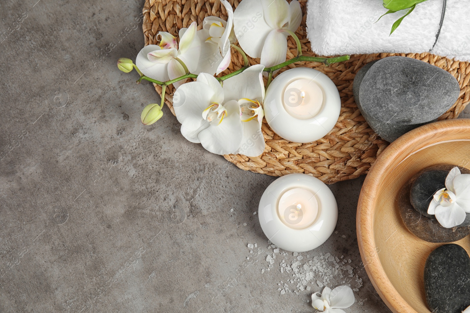 Photo of Flat lay composition with spa stones and candles on gray background. Space for text