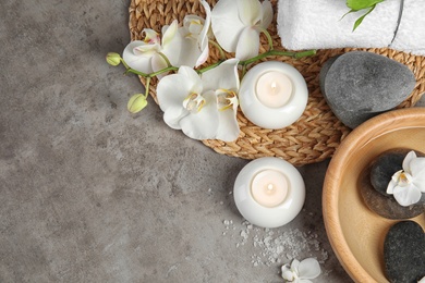 Flat lay composition with spa stones and candles on gray background. Space for text