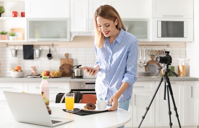 Photo of Food blogger taking photo of breakfast in kitchen