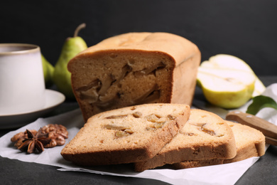 Photo of Composition with tasty pear bread on black slate table, closeup. Homemade cake