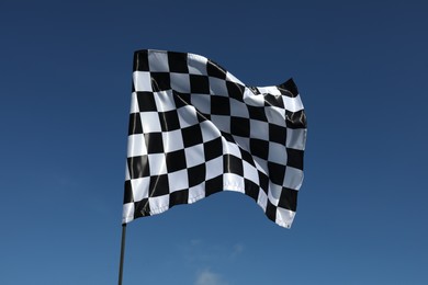 Photo of One checkered flag against blue sky outdoors