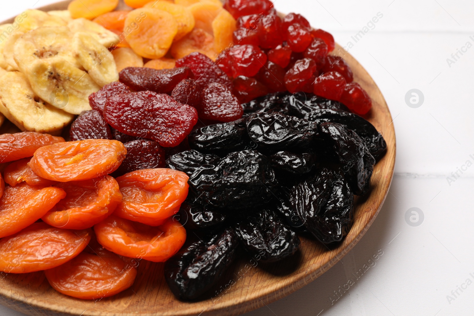 Photo of Delicious dried fruits on white table, closeup