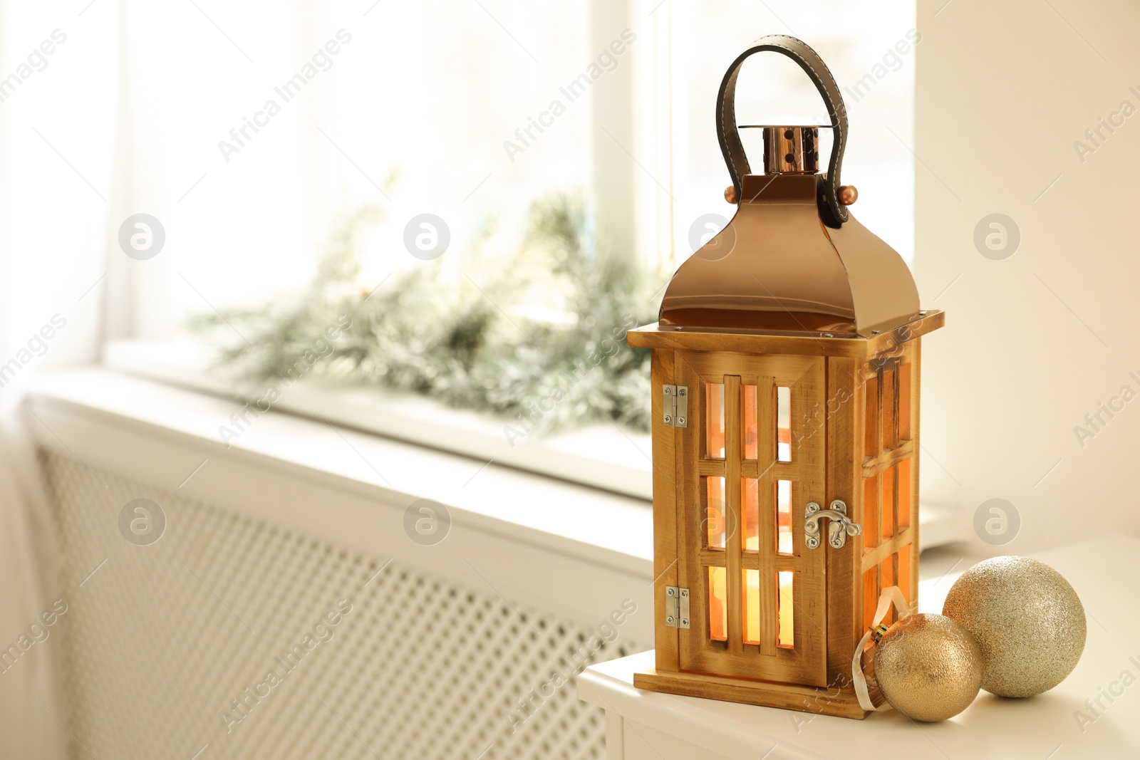 Photo of Beautiful decorative Christmas lantern with burning candle on window sill. Space for text