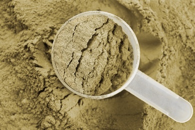 Photo of Hemp protein powder and measuring scoop, closeup