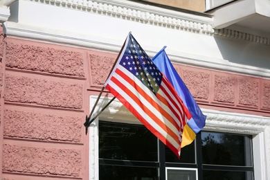 Flags of Ukraine and USA on building facade