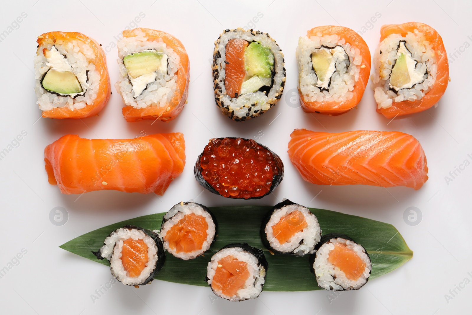 Photo of Different tasty sushi rolls on white background, flat lay