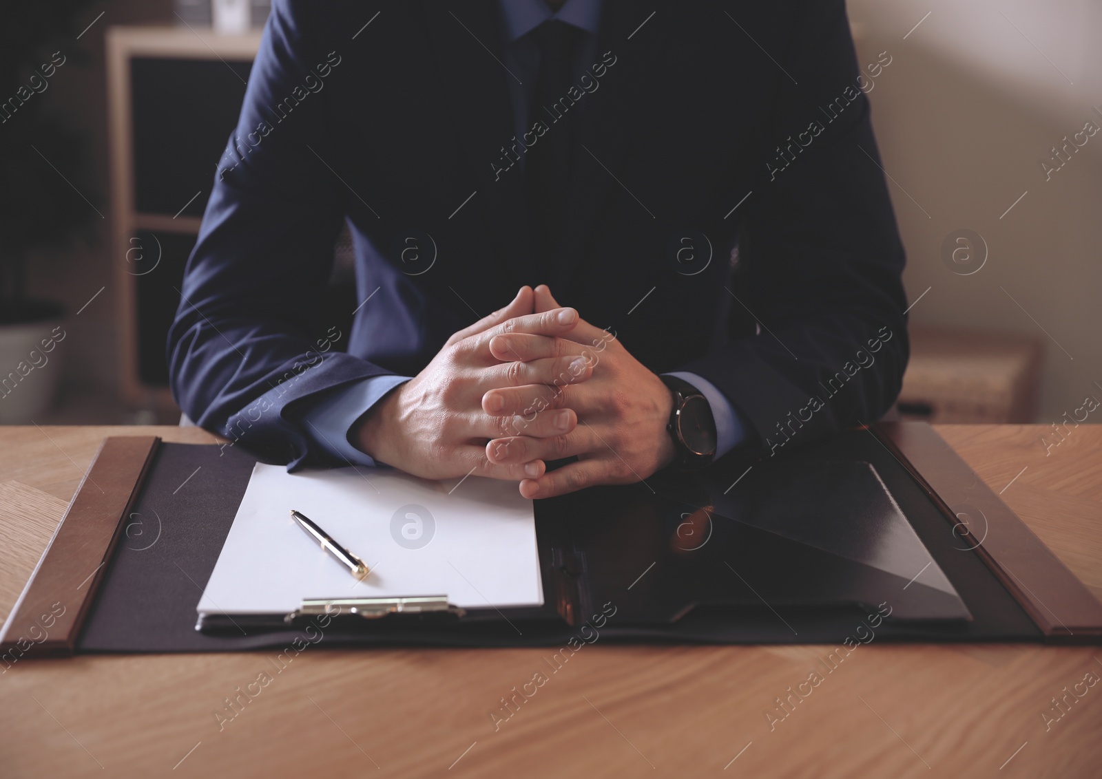 Photo of Male lawyer at table in office, closeup