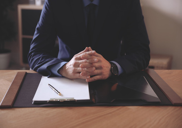 Male lawyer at table in office, closeup