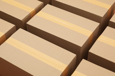 Photo of Many cardboard boxes as background, closeup view