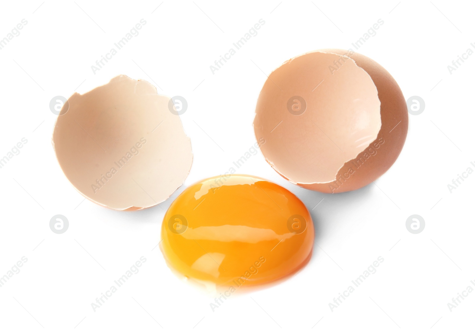 Photo of Egg yolk with cracked shell on white background