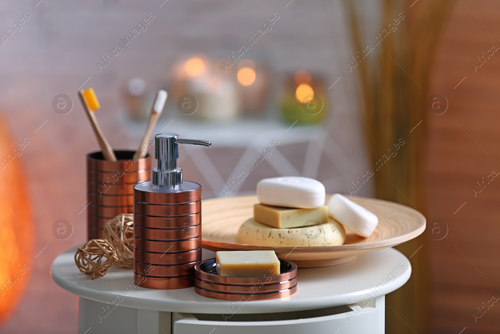 Photo of Composition with soap and toiletries on table against blurred background. Space for text