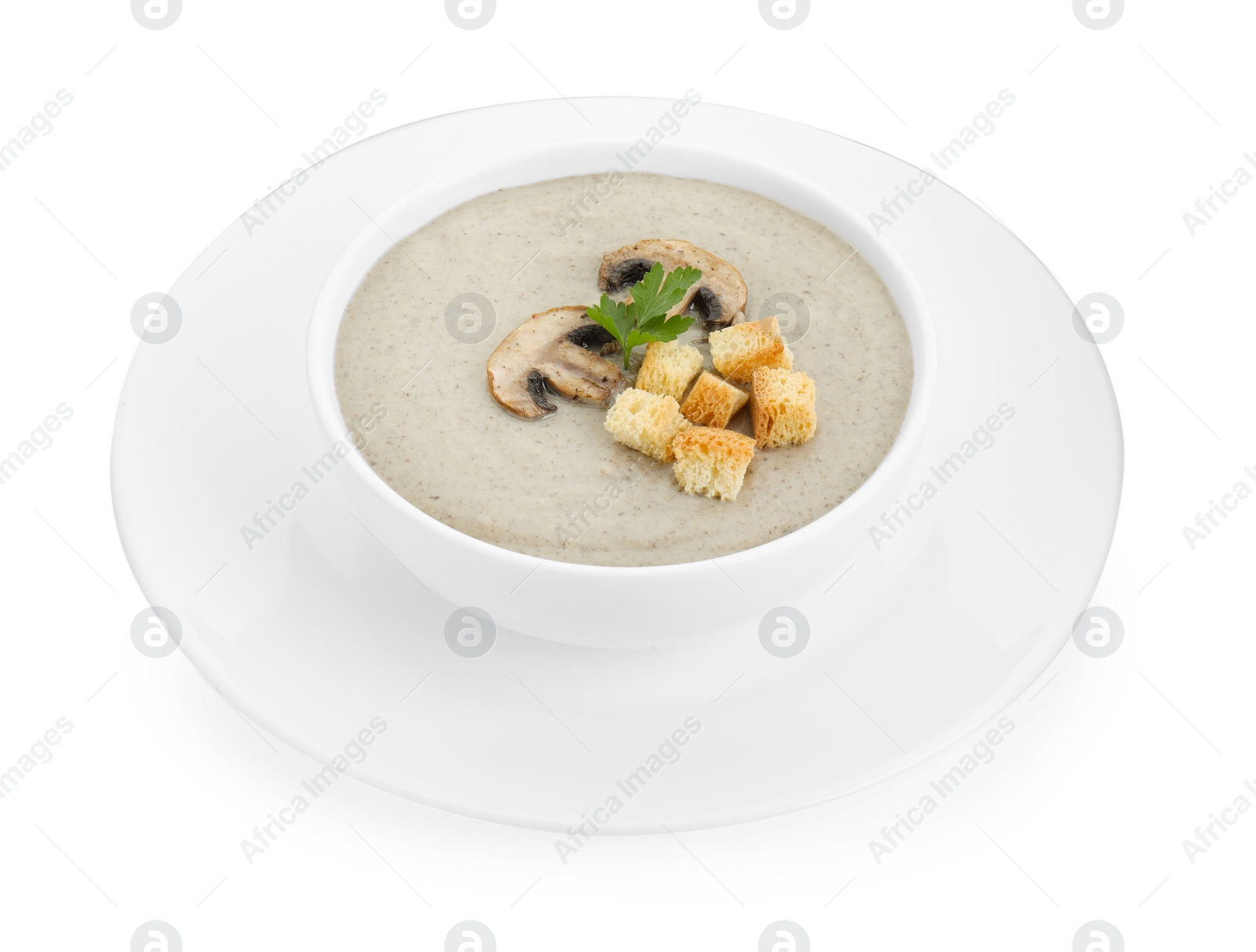 Photo of Delicious mushroom cream soup with croutons in bowl isolated on white