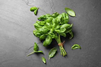 Bunch of fresh basil on grey table, flat lay