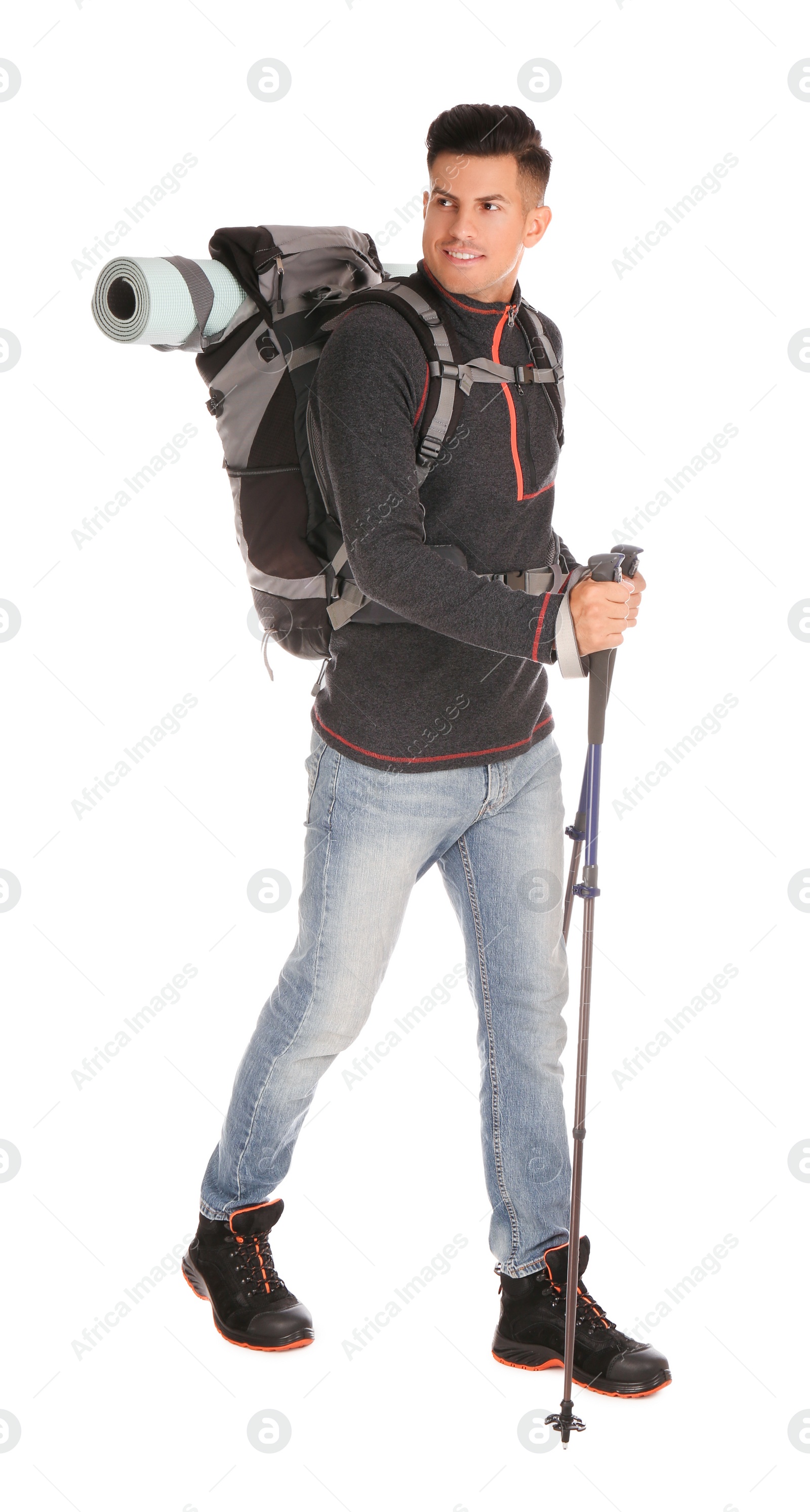 Photo of Male hiker with backpack and trekking poles on white background