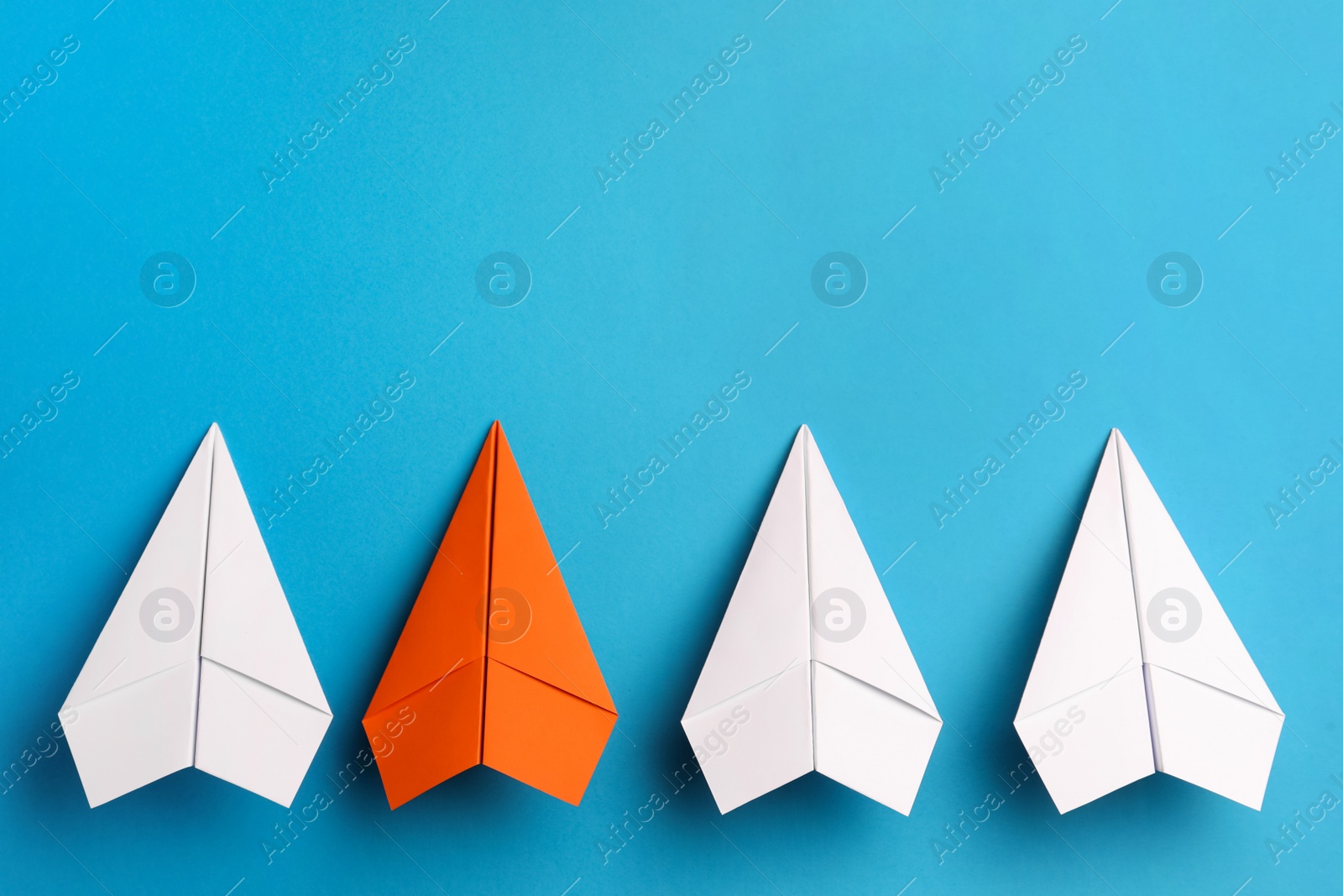 Photo of Flat lay composition with paper planes on light blue background, space for text